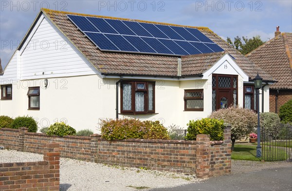 Architecture, Environment, Solar Panels, Alternative Energy Electricity Solar photovoltaic roof panels on detached bungalow house for electricity conversion. 
Photo : Paul Seheult