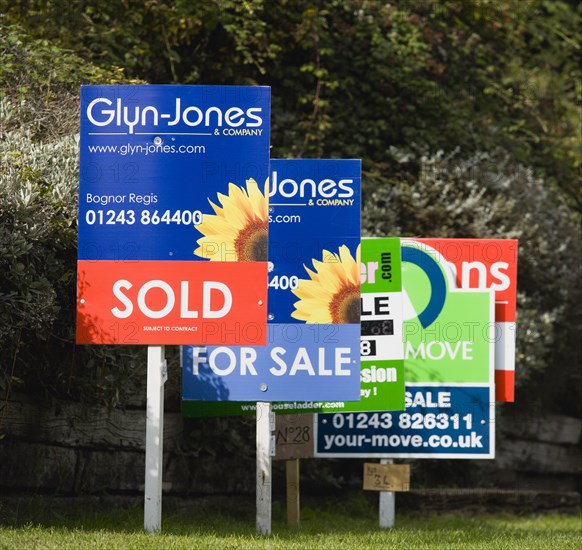 Business, Finance, Real Estate, Estate agents signs on posts advertising property for sale and sold. 
Photo : Paul Seheult