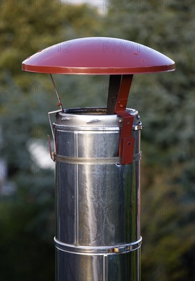 Architecture, Building, Detail, Rain top chimney cowl on top of stainless steel flue of wood burning stove. 
Photo : Paul Seheult