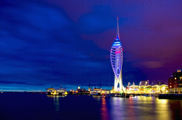 England, Hampshire, Portsmouth, Spinnaker Tower and Gunwharf Quays illuminated at night. 
Photo : Chris Penn