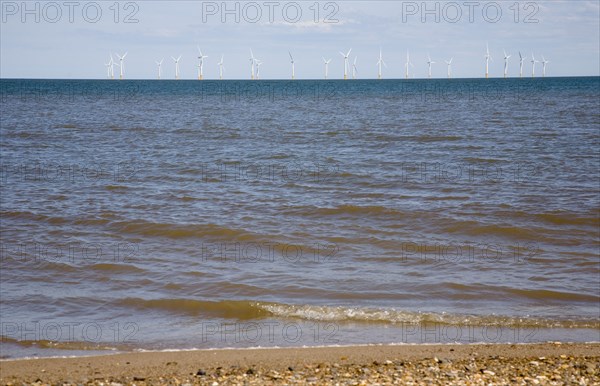 Wind Farm offshore on the horizon showing turbine blades.