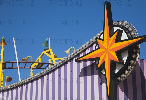 Facade of amusement arcade in clear blue sky.