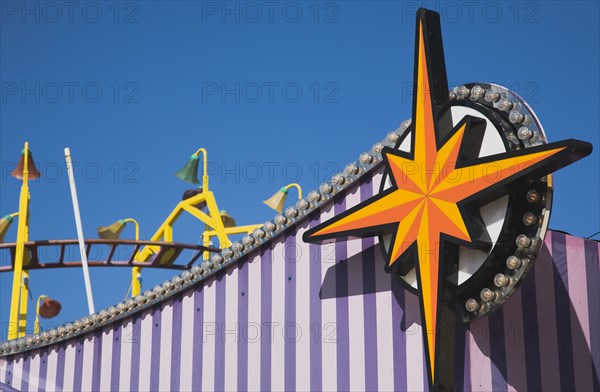 Facade of amusement arcade in clear blue sky.