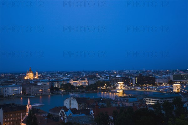 Buda Castle District view over Danube and Pest with St Stephen's Basilica illuminated.