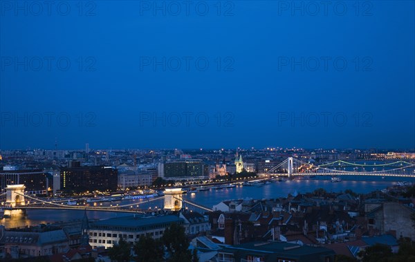 Buda Castle District view over Danube and Pest with Memorial Chain Bridge illuminated.