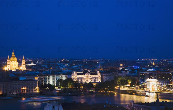 Buda Castle District view over Danube and Pest with St Stephen's Basilica illuminated.