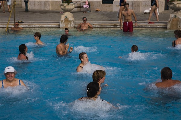 Pest Mixed group outdoor bathing in summer at Szechenyi thermal baths largest in Europe.