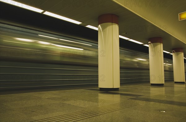 Underground train leaving platform on Metro system.