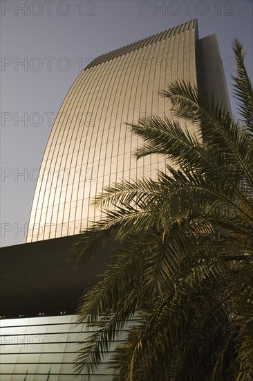 National Bank of Dubai building shining in afternoon sunlight overlooking the Creek.