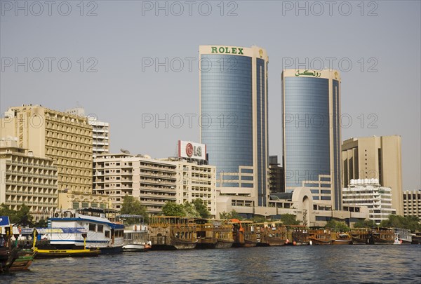 Creek with Twin Towers shopping mall and skyline behind.