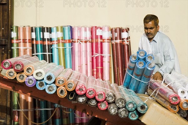 Expat from subcontinent loading colourful textiles at Souk on Bur Dubai side of the Creek.