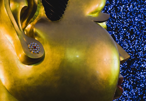 Contemporary Statue head with Christmas tree outside shopping mall.