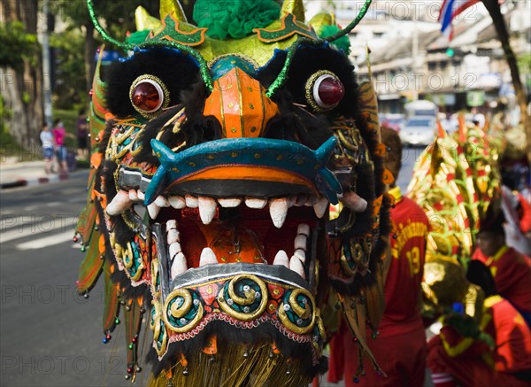 Dragon Dance head carried in parade celebrating local temple on New Road first paved road in the city.