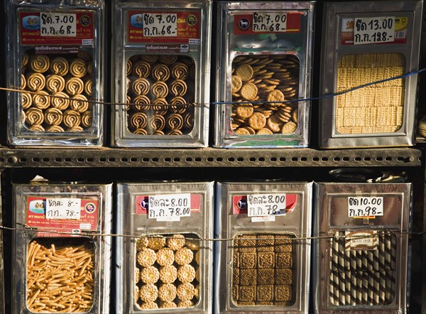 Biscuits on sale loose by weight from display tins on New Road the first surfaced road in the city.