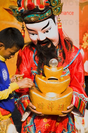 Imperial Chinese performer colecting donations for Chinese New Year.