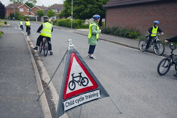 School children being taught cycle safety lessons on public roads.