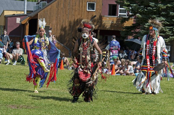 Pow Wow at the Blackfoot Arts & Heritage Festival to celebrate Parks Canada's centennial Head dancers Jenny Yellow Horn and Aryson Black Plume centre in full regalia and face paint