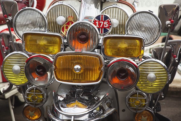 Elaborately decorated Mopeds on Madeira Drive during motorbike festival.