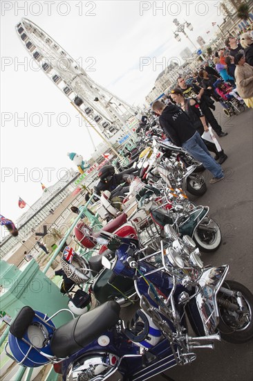 Elaborately decorated Mopeds on Madeira Drive during motorbike festival.