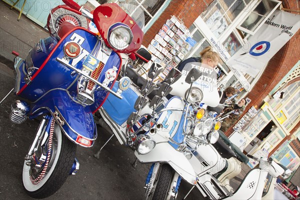 Elaborately decorated Mopeds on Madeira Drive during motorbike festival.