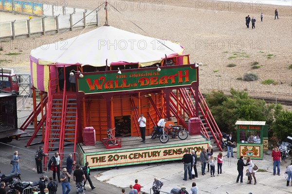 Wall of death motorcycle fairground attraction on Madeira Drive during motorbike festival.