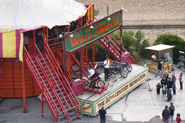 Wall of death motorcycle fairground attraction on Madeira Drive during motorbike festival.