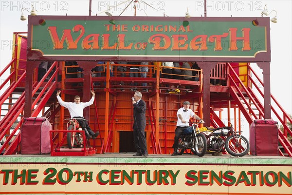 Wall of death motorcycle fairground attraction on Madeira Drive during motorbike festival.