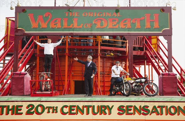 Wall of death motorcycle fairground attraction on Madeira Drive during motorbike festival.