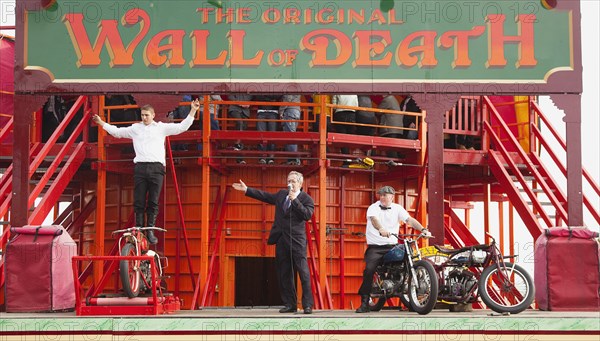 Wall of death motorcycle fairground attraction on Madeira Drive during motorbike festival.