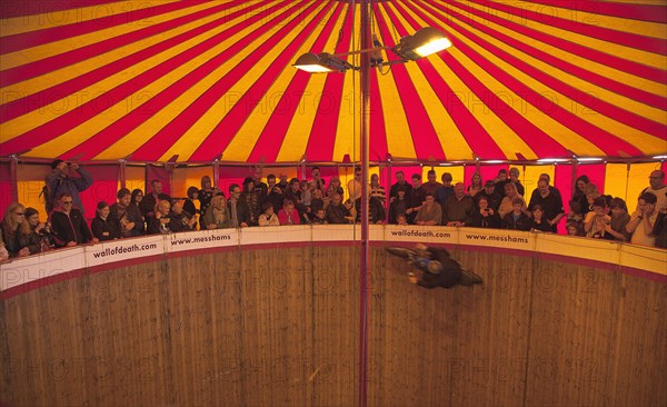 Wall of death motorcycle fairground attraction on Madeira Drive during motorbike festival.