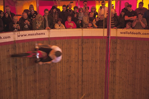 Wall of death motorcycle fairground attraction on Madeira Drive during motorbike festival.