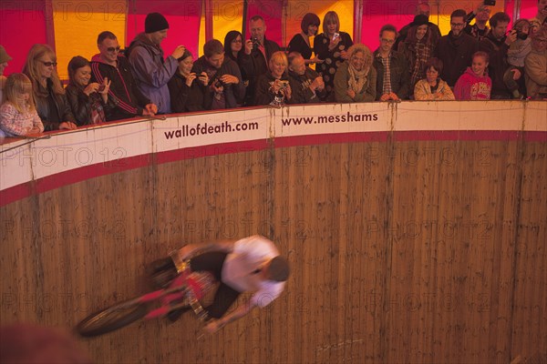 Wall of death motorcycle fairground attraction on Madeira Drive during motorbike festival.