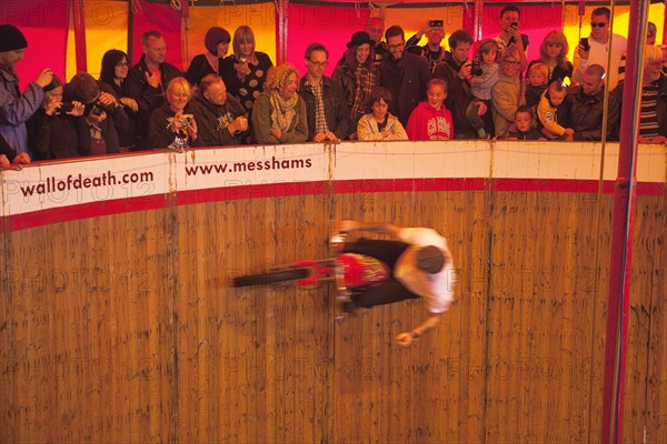 Wall of death motorcycle fairground attraction on Madeira Drive during motorbike festival.