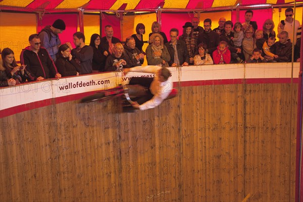 Wall of death motorcycle fairground attraction on Madeira Drive during motorbike festival.