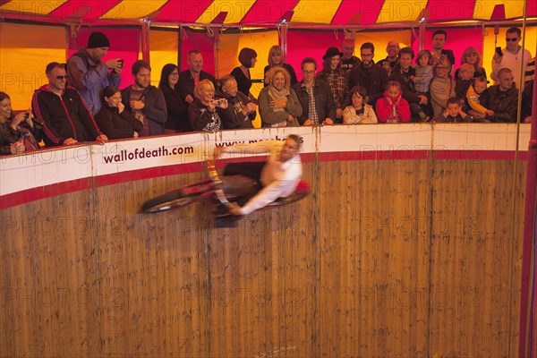 Wall of death motorcycle fairground attraction on Madeira Drive during motorbike festival.