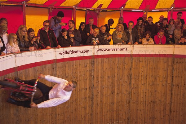 Wall of death motorcycle fairground attraction on Madeira Drive during motorbike festival.