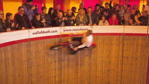 Wall of death motorcycle fairground attraction on Madeira Drive during motorbike festival.