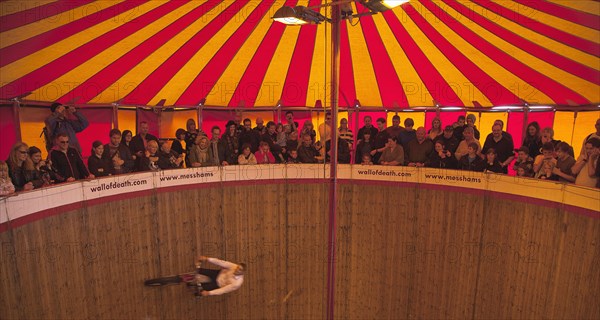 Wall of death motorcycle fairground attraction on Madeira Drive during motorbike festival.