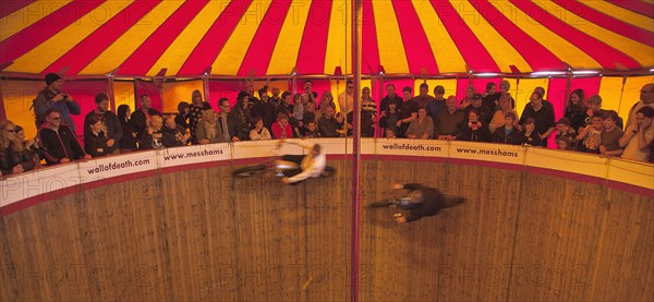 Wall of death motorcycle fairground attraction on Madeira Drive during motorbike festival.