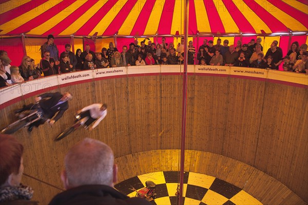 Wall of death motorcycle fairground attraction on Madeira Drive during motorbike festival.