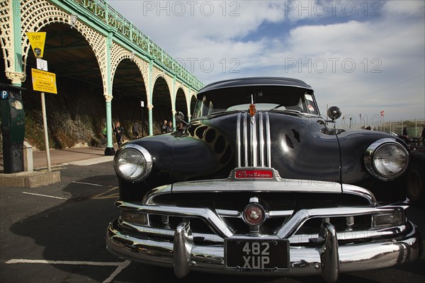 Old American Pontiac automobile on Madeira Drive during classic car festival.