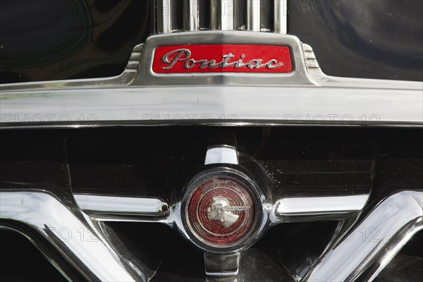 Old American Pontiac automobile on Madeira Drive during classic car festival.