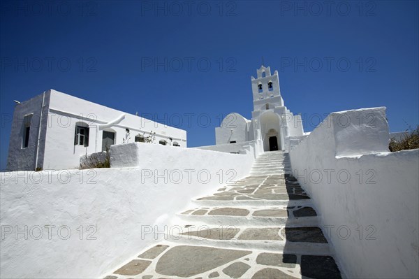 Landscape format low angle photograph of the church inside Chrissopigi monastery which is build on the top of a cliff nearby Platis Yalos village and it is famous for housing the miraculous icon of Panagia Chrissopigi.