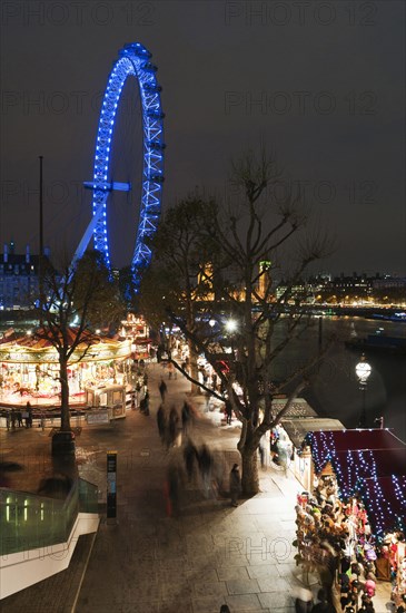 Southbank Christmas market and the London Eye illuminated at night.