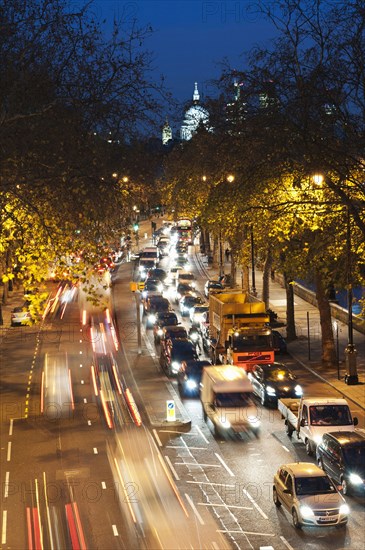 Rush hour traffic along the Embankment with St Paul's Cathedral in the background.