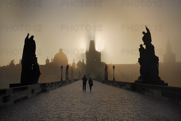 Strolling in the post dawn rays of sun and mist on Charles Bridge.