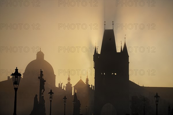 The Calvary statue in early morning mist on Charles Bridge