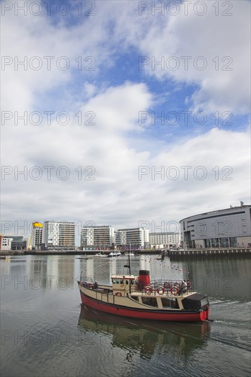 Titanic Quarter tour boat taking tourists on sightseeing cruise.