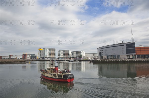 Titanic Quarter tour boat taking tourists on sightseeing cruise.