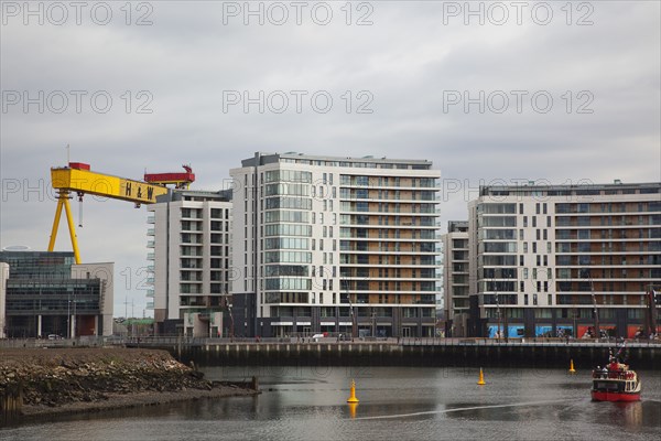 Titanic Quarter Modern apartment blocks on the site of the Harland & Wolff shipyard with sightseeing cruise boat.